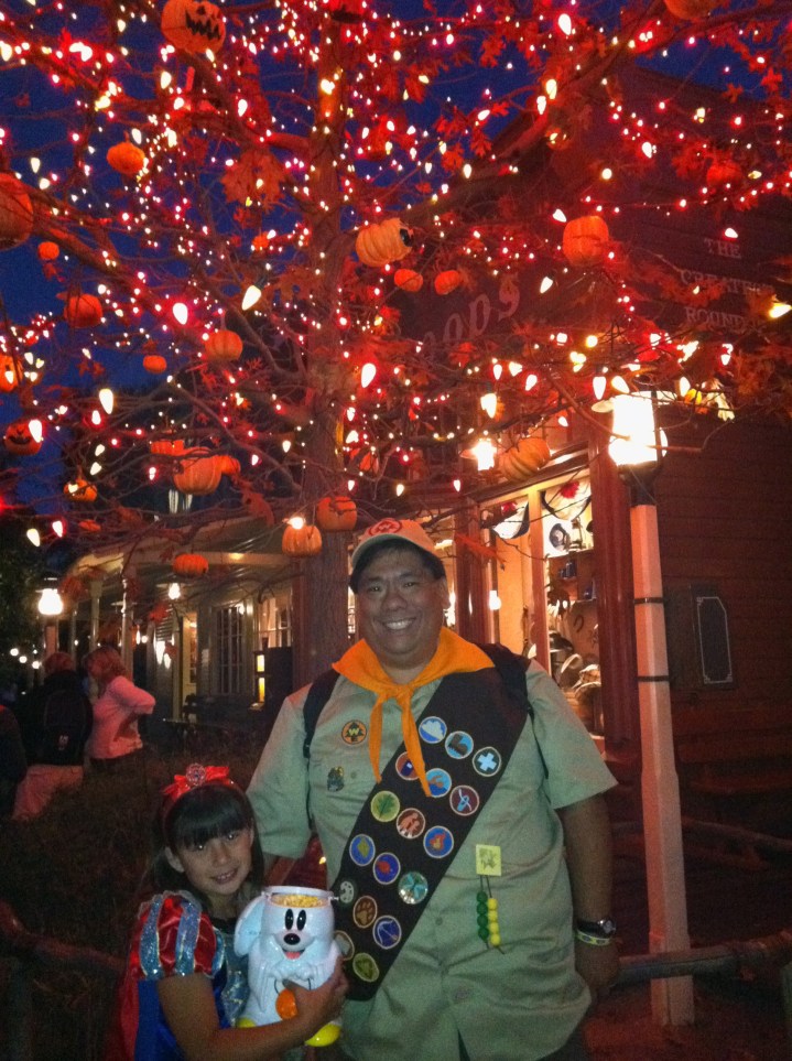 At night in front of the Halloween Tree with our Mickey Ghost Popcorn