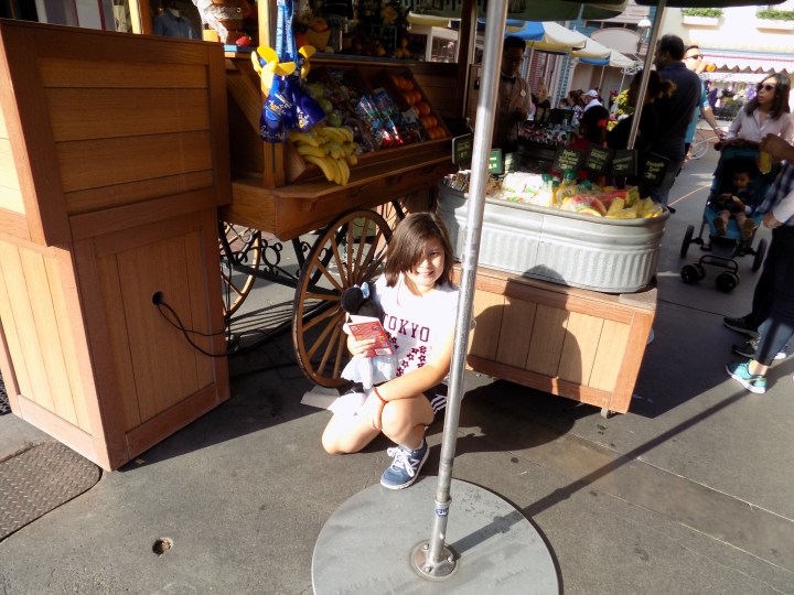 Pointing out a less obvious Mickey in the undercarriage of the fruit cart