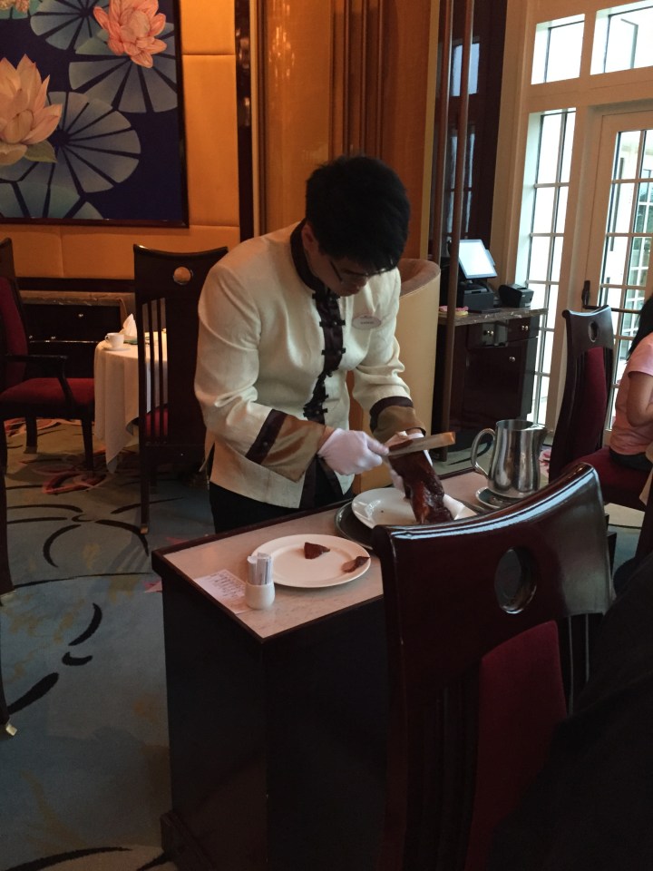 Our server at Crystal Lotus slicing roast duck