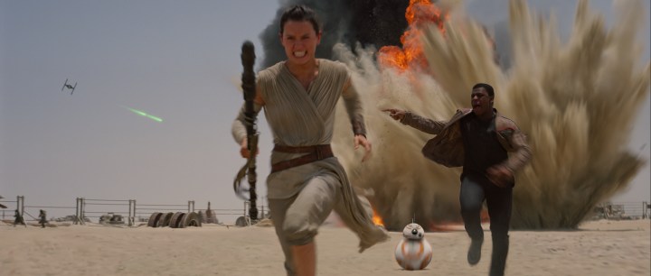 Rey and Finn running from the First Order's strafing run on Jakku. Ph: Film Frame..©Lucasfilm 2015