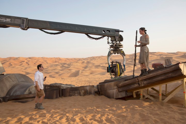 Star Wars: The Force Awakens..L to R: Director J.J. Abrams w/ actress Daisy Ridley (Rey) on set...Ph: David James..copyright 2015 Lucasfilm Ltd.; TM. All Right Reserved.