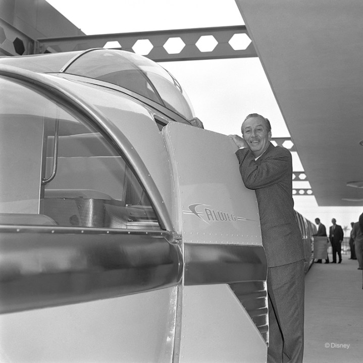 Walt Disney poses for a photo with the then-newly-minted Disneyland Monorail expansion in Spring 1961. The expanded attraction connected Disneyland® Park to the Disneyland Hotel, allowing Guests easy transportation from one location to the other.