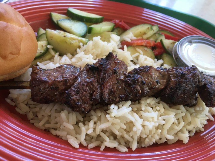 My gluten-free steak skewer platter with rice, Tzatziki sauce, cucumber salad, and gluten-free roll